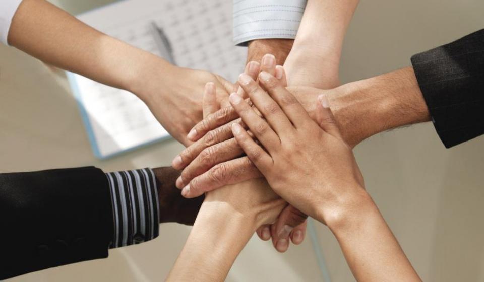 employees with all hands in