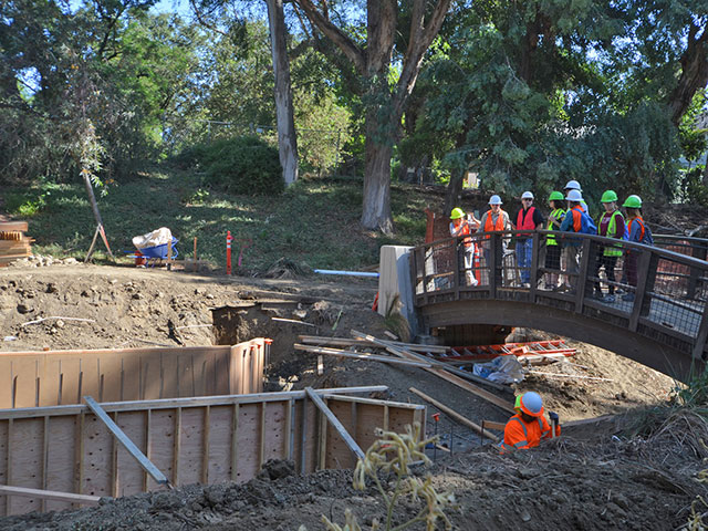 Photo of crew surveying work in the arboretum waterway.