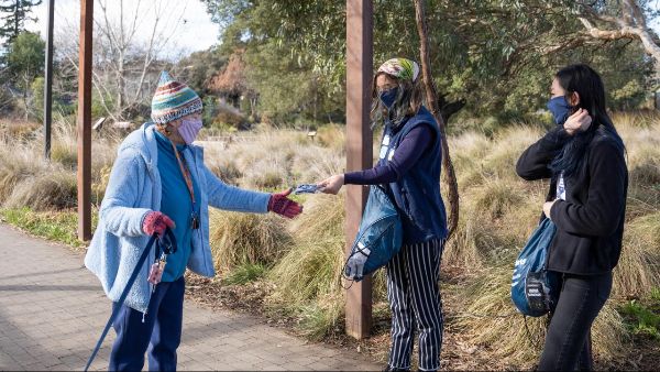 Aggie Public Health Ambassador hands out free face covering