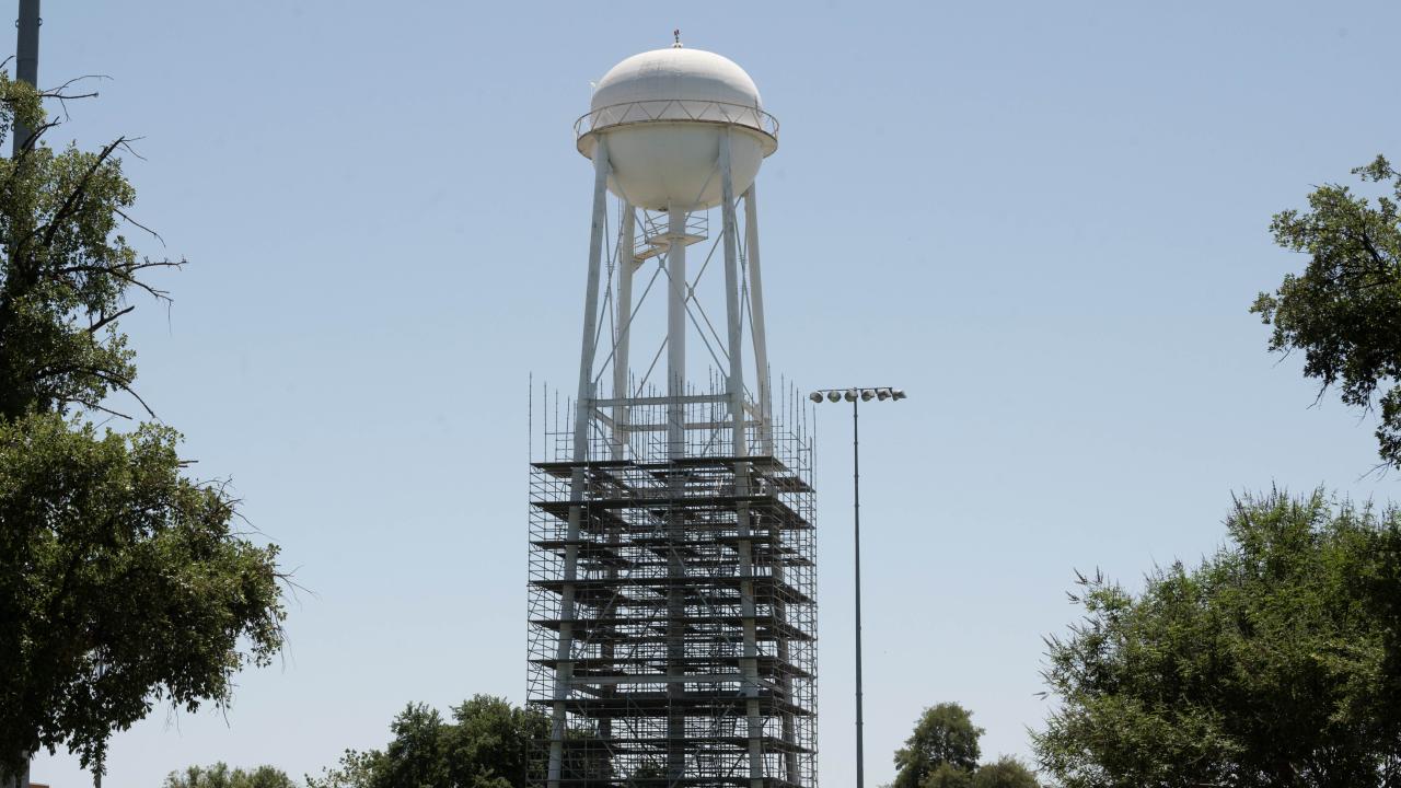 Scaffolding around the legs of a water tower on the UC Davis campus