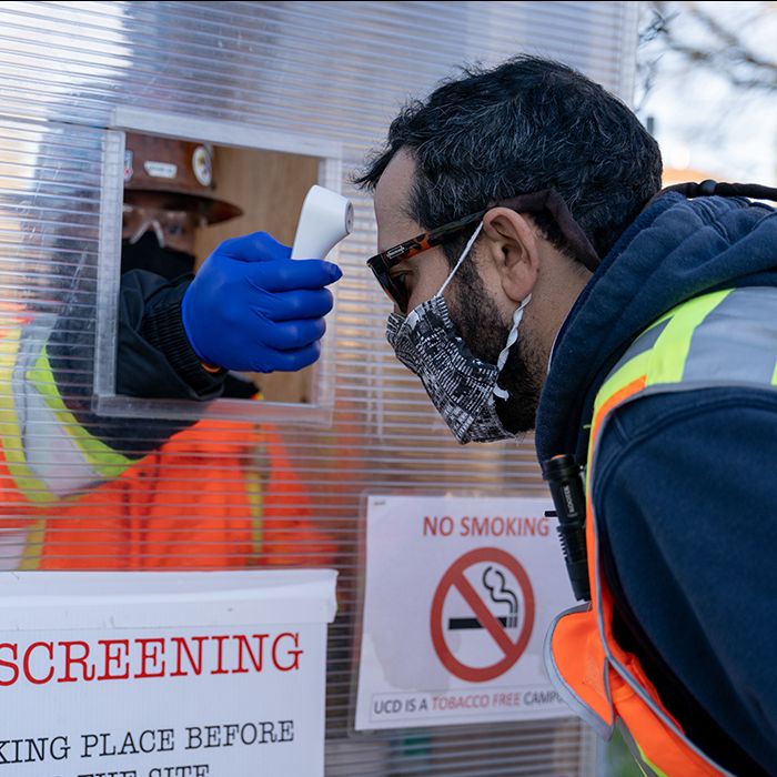 Worker gets temperature check at construction site