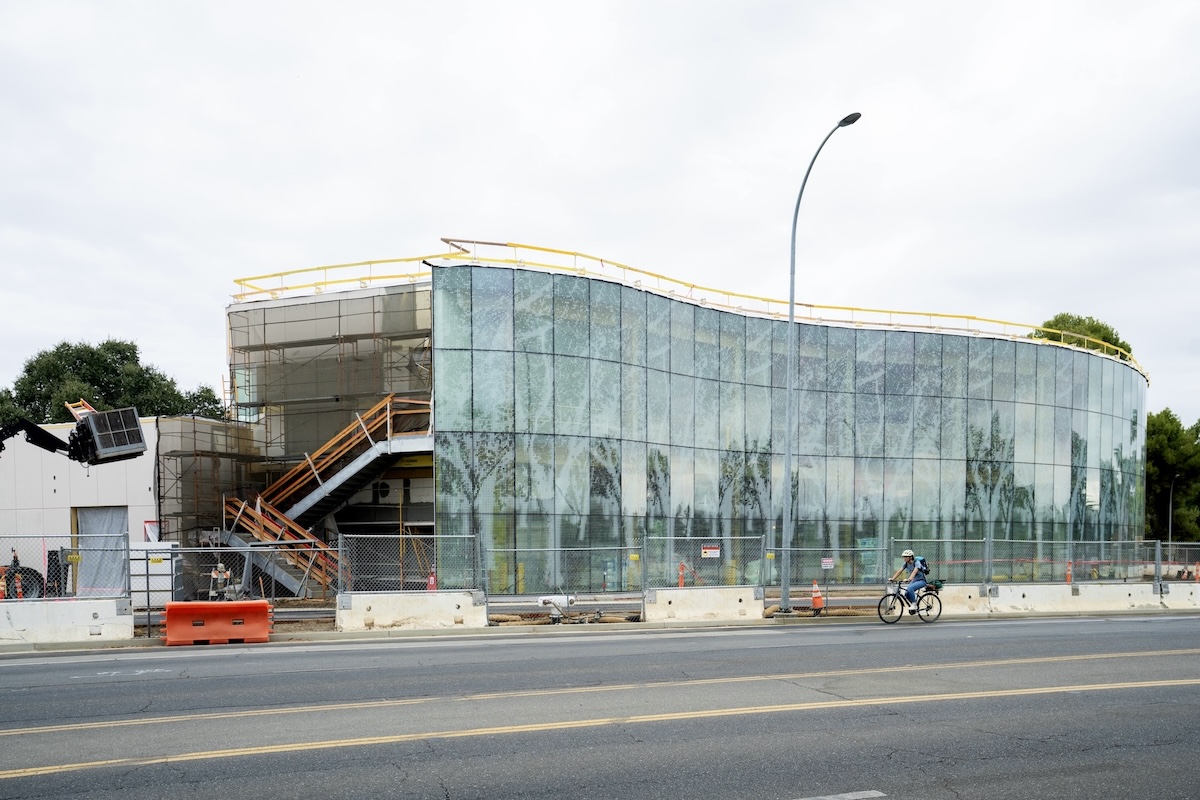The Resnick Center for Agricultural Innovation stands, partially constructed with a glass facade imprinted with a pattern of rows of trees.
