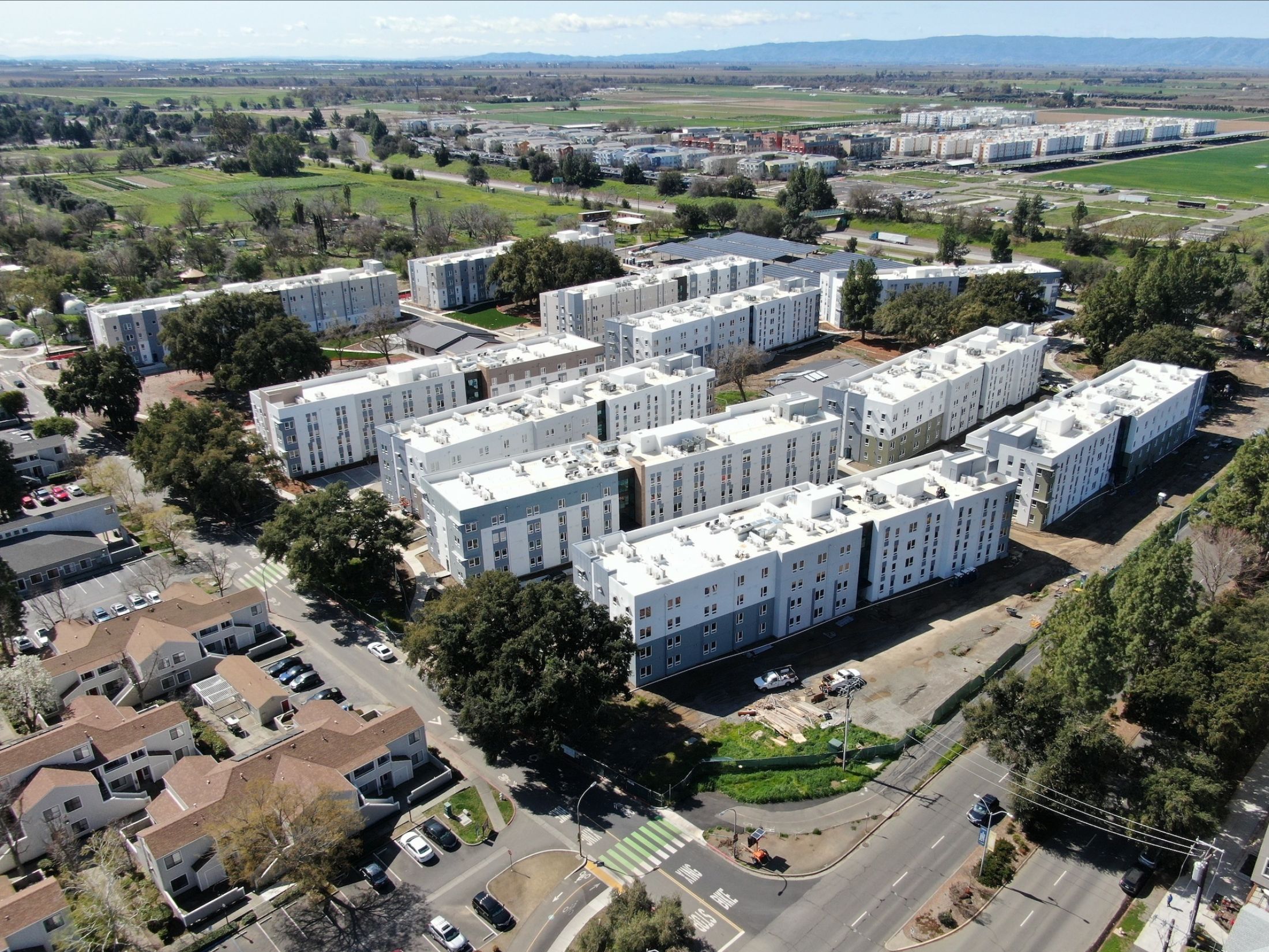 Aerial shot of Orchard Park redevelopment with several large white apartment buildings.