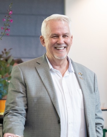 Headshot of Blair Stephenson, who is smiling.