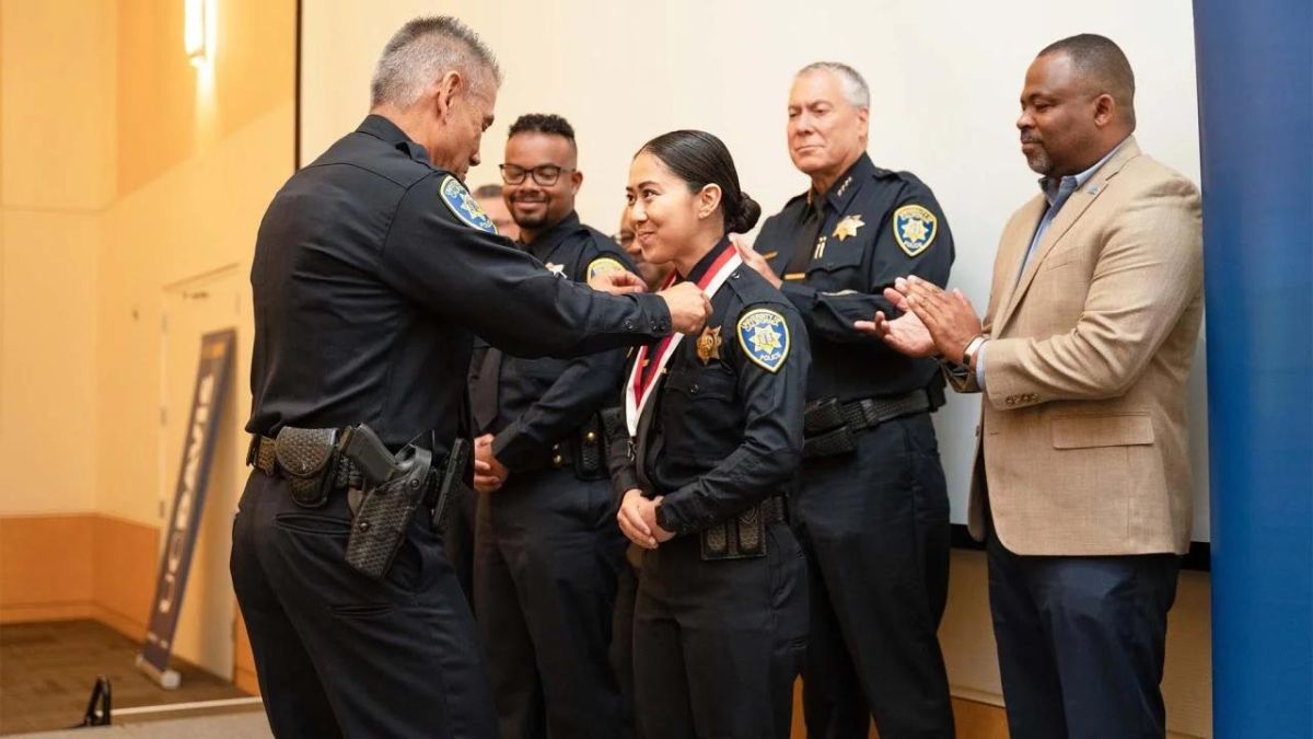 C Davis Police Chief Joe Farrow presents an officer with a medal