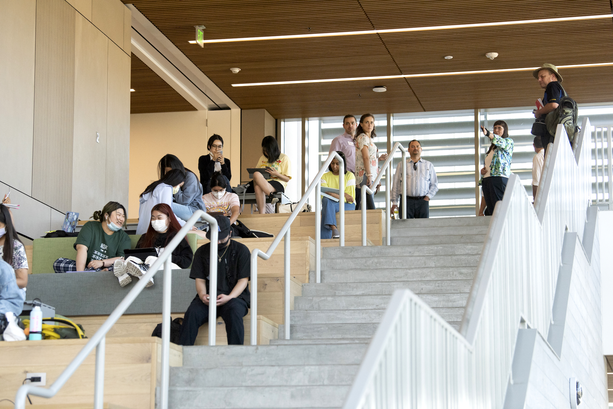 Students on the stairs at the Teaching and Learning Complex