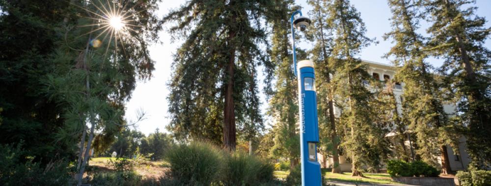 emergency call box on a campus walking path