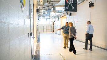 group peers from a hallway marked with hazard tape, with pirate flag overhead