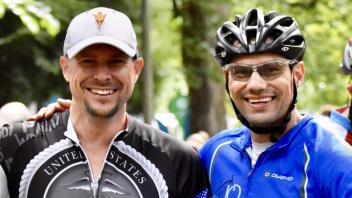 Photo of Clint Lord and his brother wearing biking gear, smiling, looking at the camera