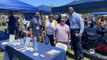 Facilities Management staff poses at their TGFS table