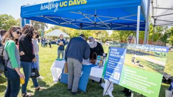 Staff members line up at the Healthy UC Davis table