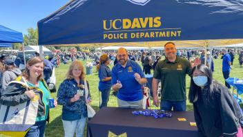 UC Davis Police Department staff members poses at their table