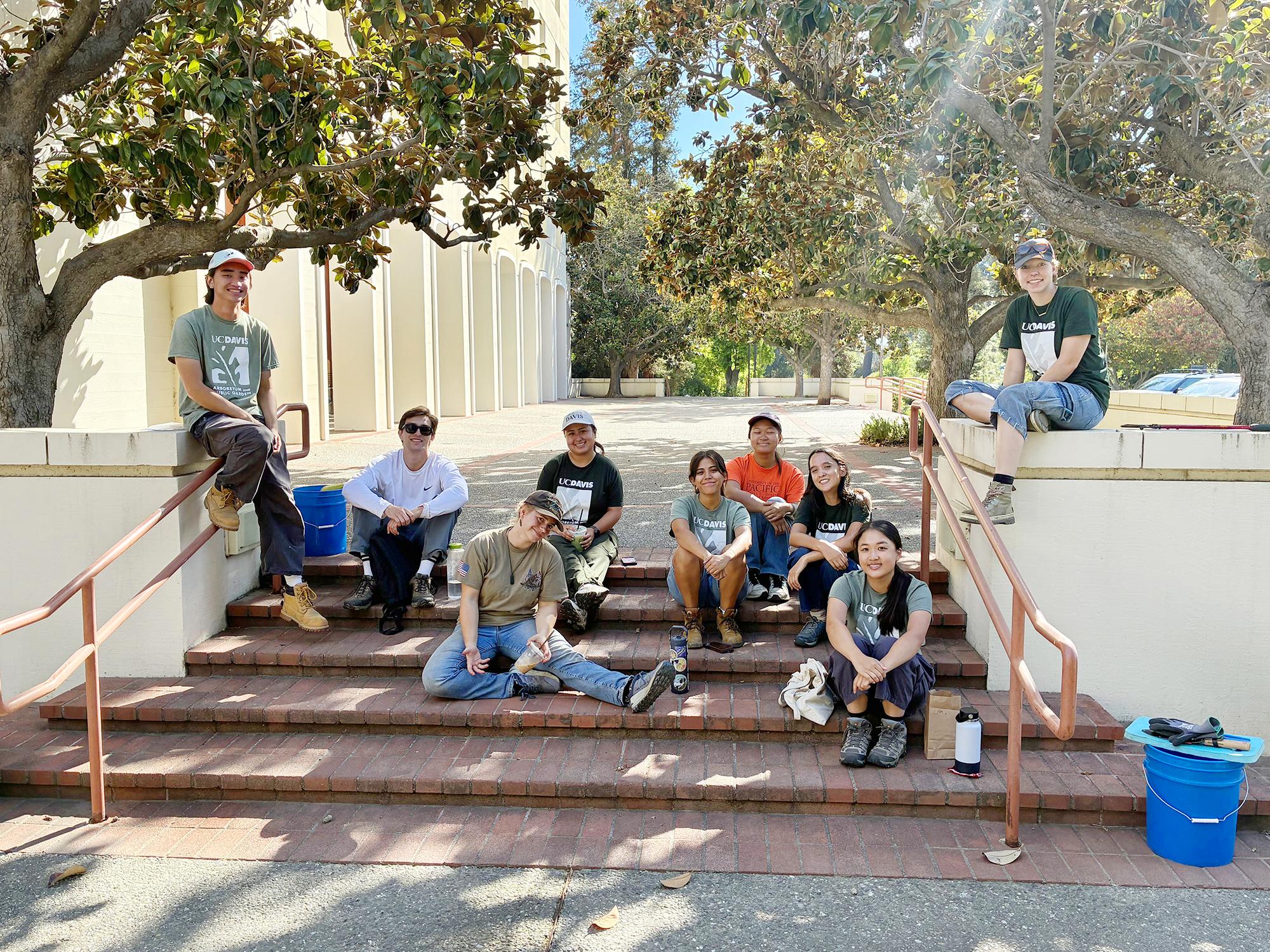 Students posing in a group shot sitting on steps outside of Mrak Hall.