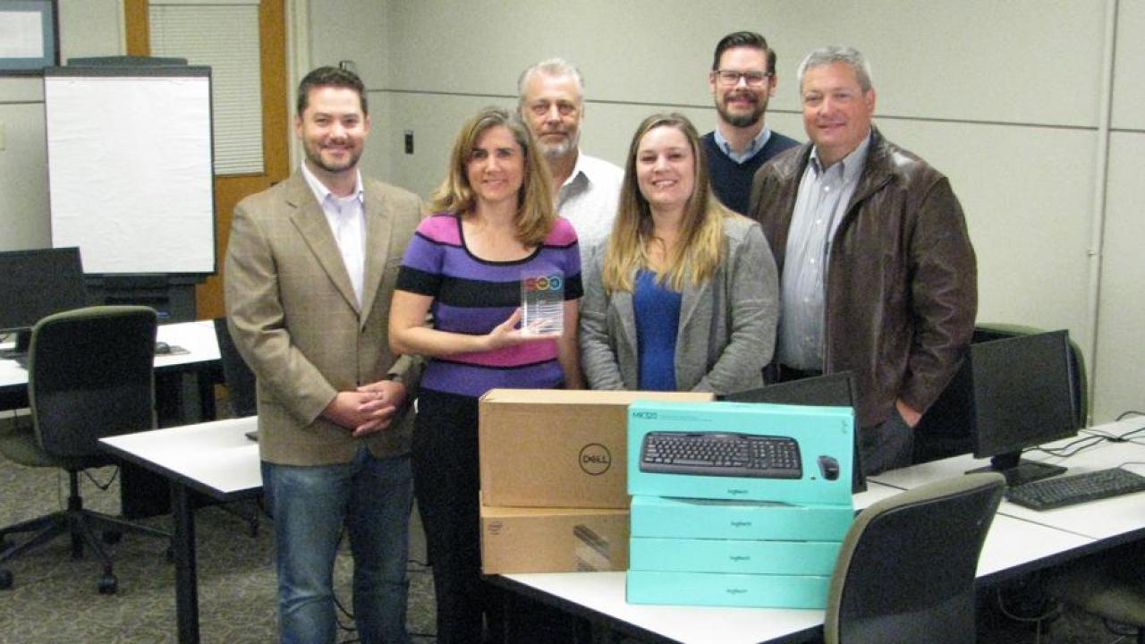 Administrative Computer Standards team, from left, Hampton Sublett, Carolyn Nordstrom, Michael Morgan, Britany Duyanovich, Steve Pigg and Tim Maguire. Not pictured: Quico Gonzalez. (Brei Thompson/UC Davis photo) Photo of staff with computer equipment.