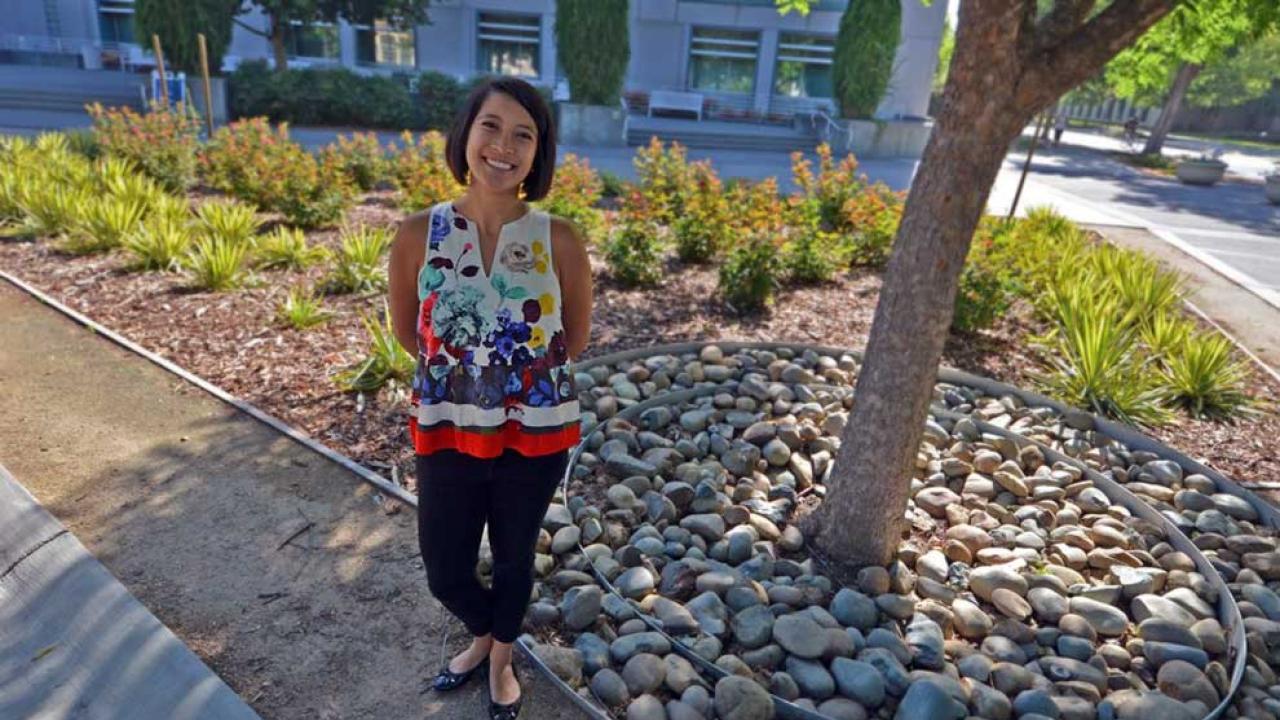 Photo of student standing in midst of landscape architecture project.