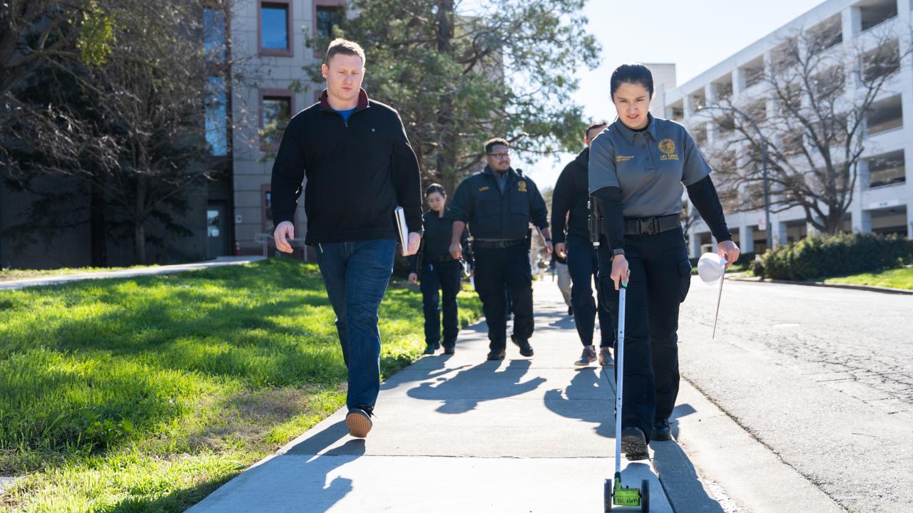 Police officer leads training with a campus safety specialist