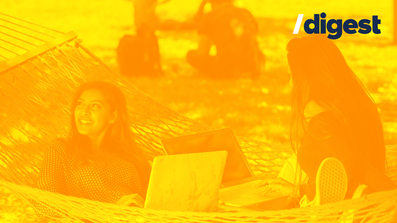 Two people with their laptops lounging in a hammock