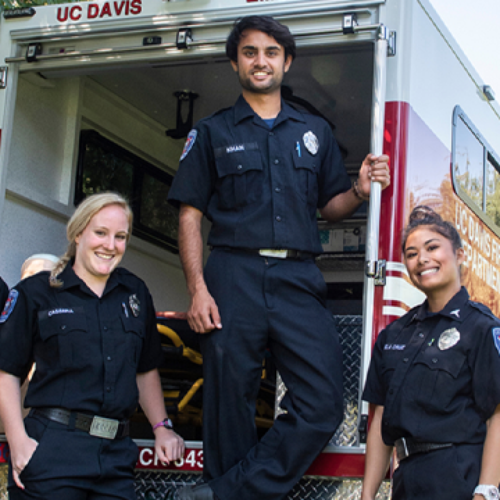 UC Davis EMTs standing in front of ambulance