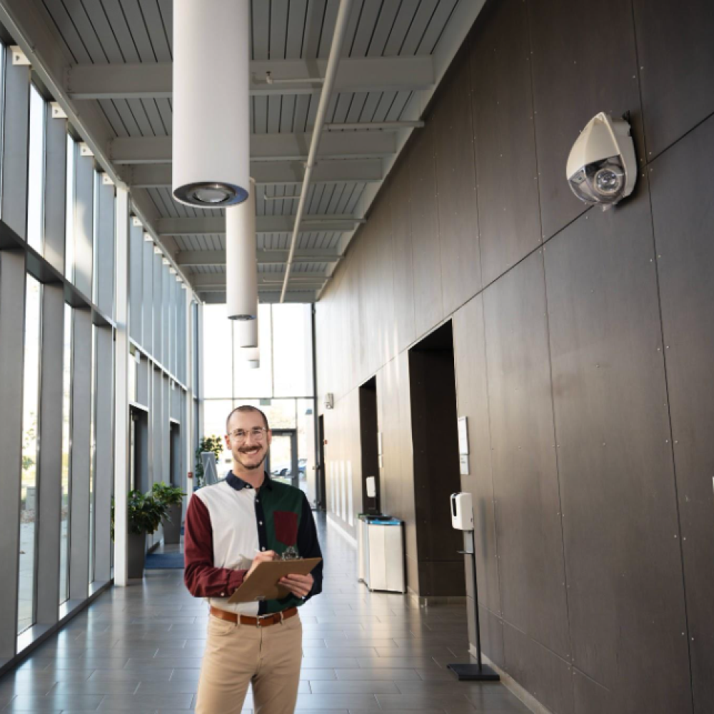 employee standing inside conference center lobby