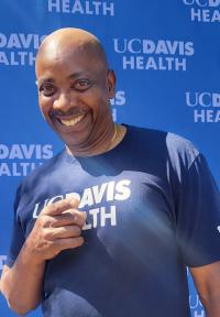 Arthur Johnson is smiling and pointing at the camera.