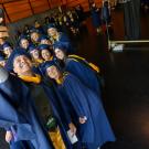 Image of a group of recent graduates taking a selfie.