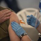 photo of someone receiving an injection in their upper arm. 