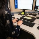 Person works at a desk with two monitors