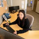 student intern working at a computer in an office