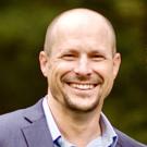 Photo of Clint Lord smiling, looking at the camera