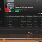 laptop on a desk showing spotify playlist called favorite quarantunes