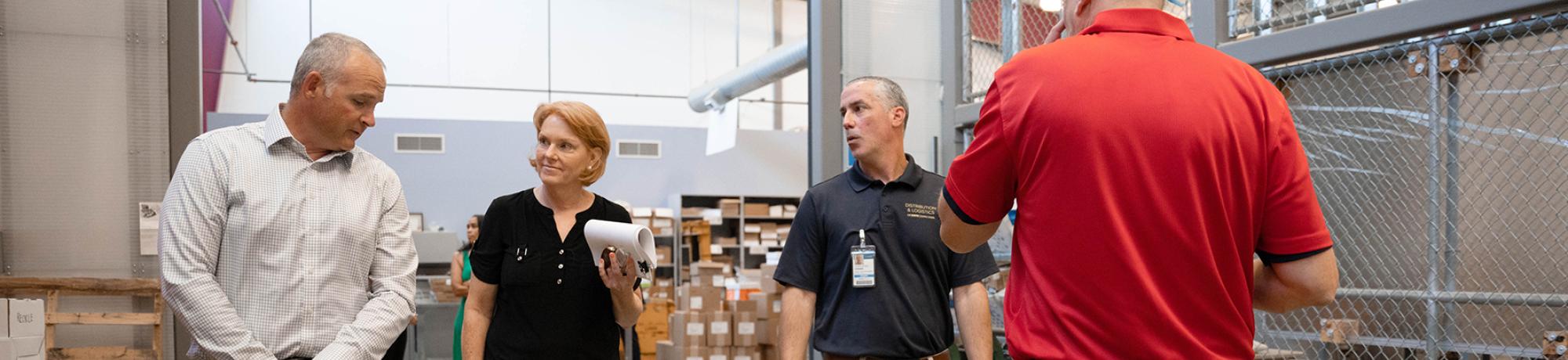 UC Davis employees walk through mail services facitility