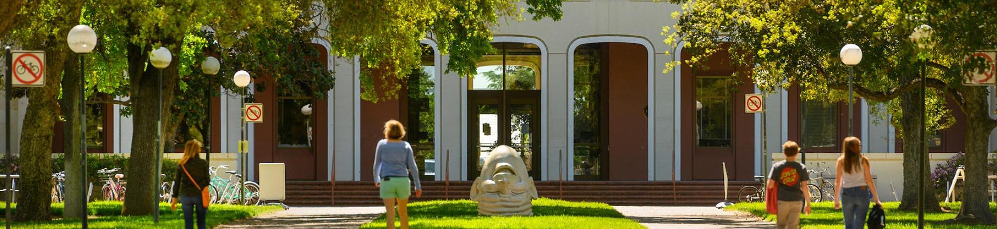 people walking in front of mrak hall